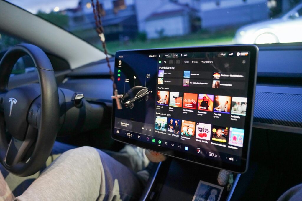 Close-up of a Tesla's digital dashboard showcasing entertainment options in Garešnica.